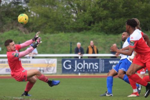 Enfields Kezie Ibe (white) lifts the ball over keeper Zaki Oualah but over the bar