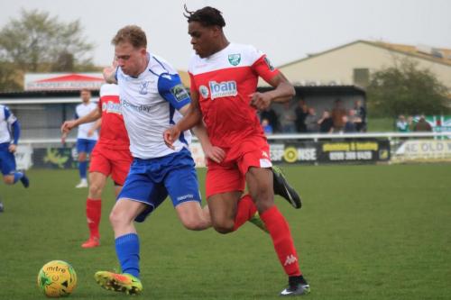 Leatherheads Izunna Ikebuasi (R) challenges Aaron Greene