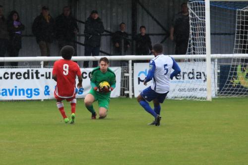 Enfield keeper Matt Nolan collects the ball ahead of Walter Figueira (L) and Taofiq Olomowewe