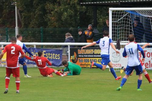 Enfield keeper Matt Nolan saves from Calum Davies