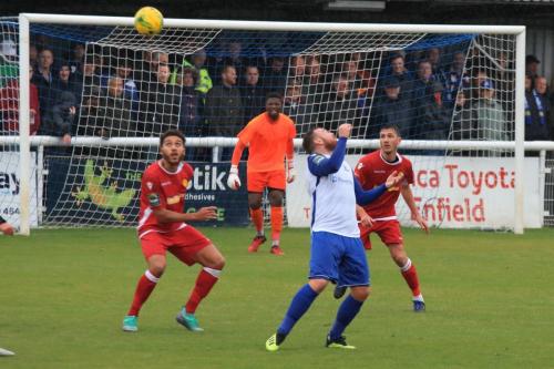 Enfields Billy Bricknell (white) flicks a header over the defence