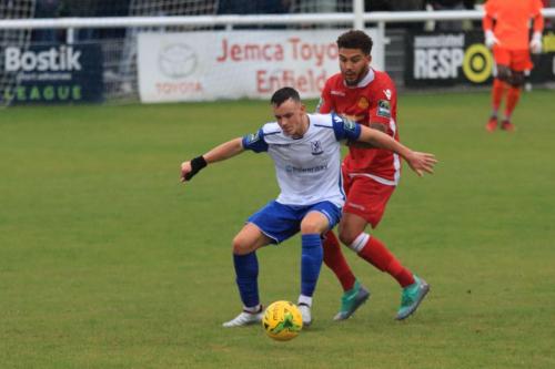 Enfields Brandon Adams (L) holds off Harry Osborne