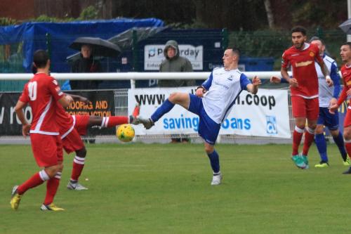 Enfields Brandon Adams (white) stretches for the ball with Kershaney Samuels