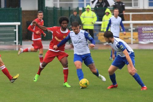 Enfields Dan Rumens (centre) and Remi Sutton and Mersthams Walter Figueira