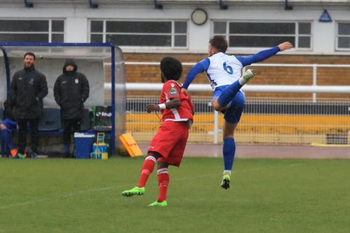 Enfields Dan Rumens heads clear from Walter Figueirax