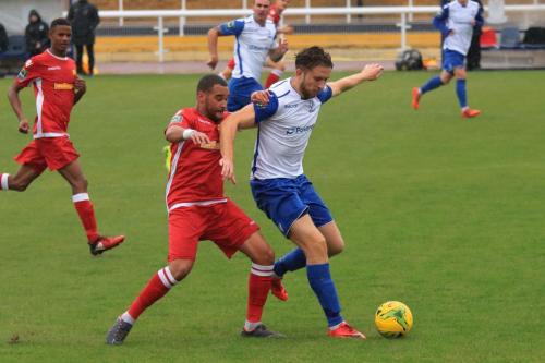Enfields Michael Abnett (red) challenges Remi Sutton