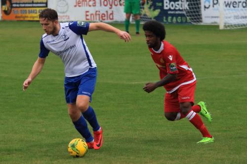 Enfields Remi Sutton (L) and Mersthams Walter Figueira