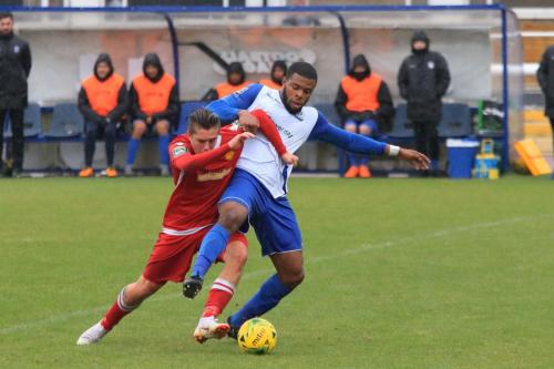 Mersthams Calum Davies (L) and Enfields Taofiq Olomowewe