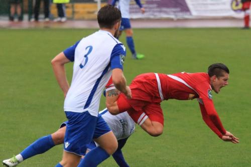 Mersthams Calum Davies (red) is brought down by Dan Rumens, who was cautioned when play stopped after the referee had played advantage