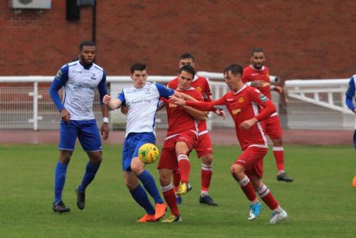 Mersthams Fabio Saraiva (red,L) clears from Josh Davison