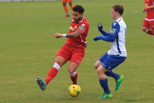 Mersthams Harry Osborne (L) clears from Aaron Greene