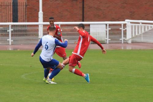 Mersthams Jake Hutchings (R) challenges Dan Rumens
