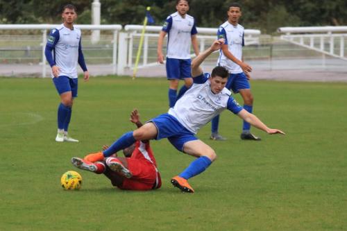 Mersthams Kershaney Samuels (red) tackles Josh Davison