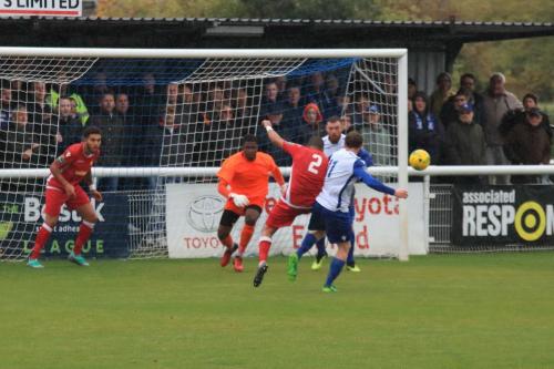 Mersthams Michael Abnett (2) knocks the ball away from Aaron Greene