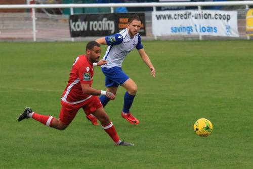 Mersthams Michael Abnett (L) and Enfields Remi Sutton