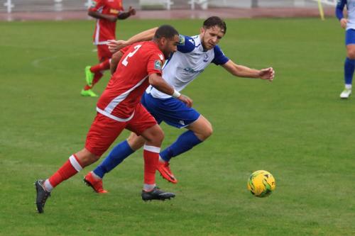 Mersthams Michael Abnett (L) and Enfields Remi Suttonx