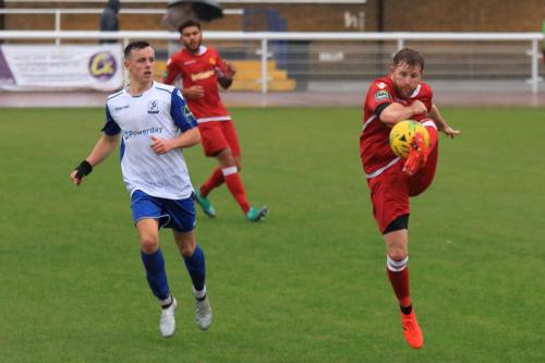 Mersthams Tom Bird (R) clears from Brandon Adams
