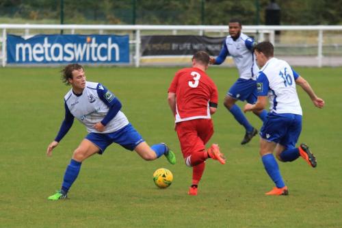 Mersthams Tom bird runs between Mickey Parcell (L) and Josh Davison