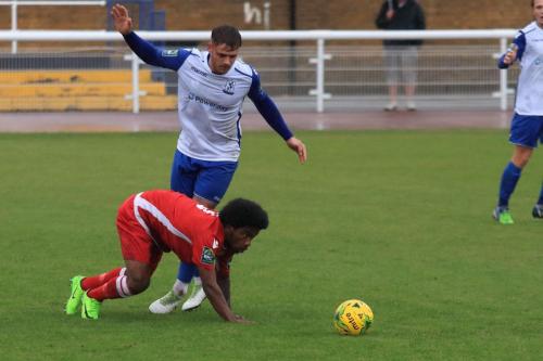 Mersthams Walter Figueira (red) and Enfields Dan Rumens