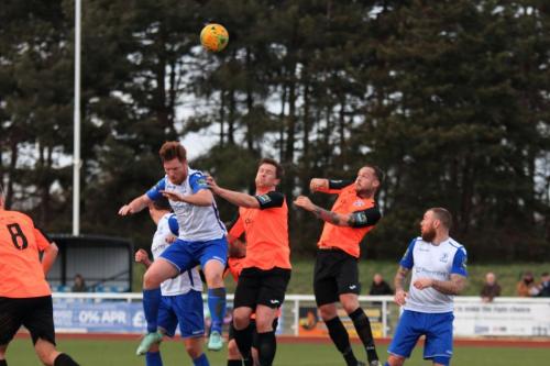 Enfields Marc Weatherstone (white) challenges Sonny Miles