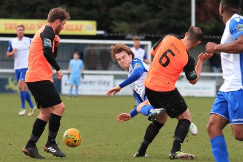Enfields Mickey Parcell (white) picks up a yellow card for a challenge on Arthur Lee
