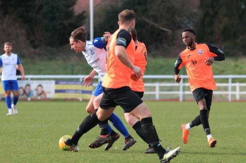 Enfields Sam Youngs challenged by Sonny Miles, watched by DSean Theobalds (R) and Arthur Lee
