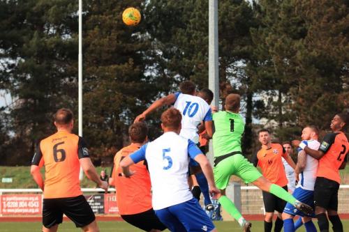 Tonbridge keeepr Jonathan Henly punches clear from Kezie Ibe (10)