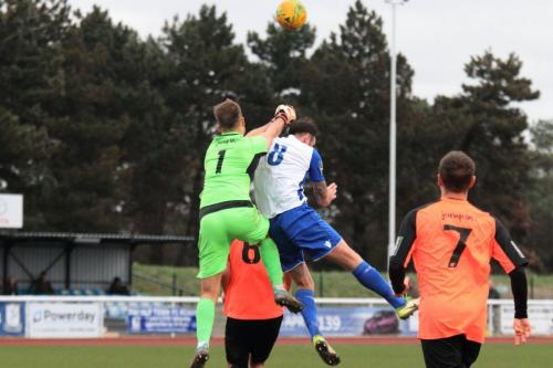 Tonbridge keeper Jonathan Henly punches clear from Matt Johnson
