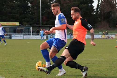 Tonbridges Arthur Lee (R) clears from Dan Rumens
