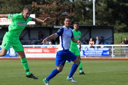 Dorkings Chris Boulter (L) heads clear before the ball can reach Liam Hope