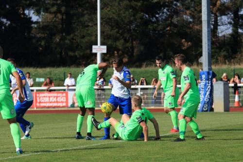 Dorkings Chris Boulter (on floor) challenges Sam Youngs