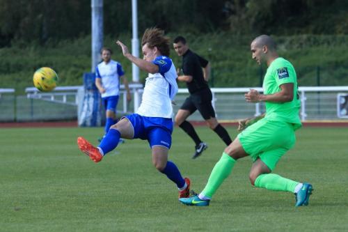 Dorkings Sami El-Abd (R) clears from Sam Chaney