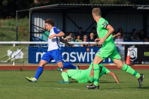 Dorkings Sami El-Abd (centre) tackles Lewis Taaffe