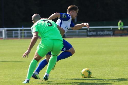 Enfields Lewis Taaffe (white) runs past Sami El-Abd