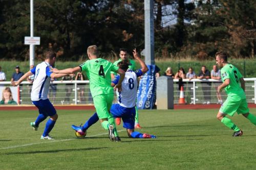 Enfields Liam Hope (L) and Sam Youngs tussle for a loose ball with Dorkings Chris Boulter