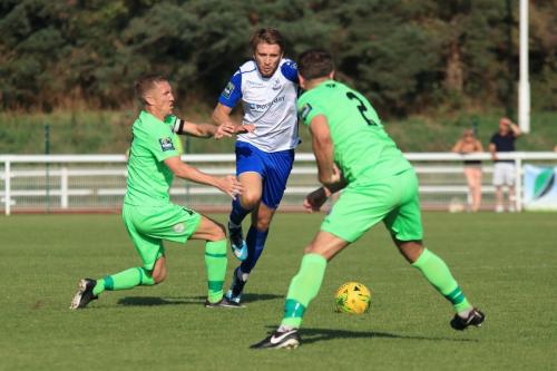 Enfields Remi Sutton runs at Chris Boulter (L) and Ben Dyett
