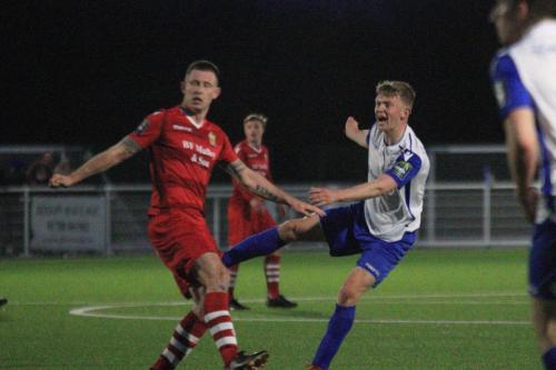 Enfields Joe Payne (white) shoots over the bar watched by Charlie Stimson