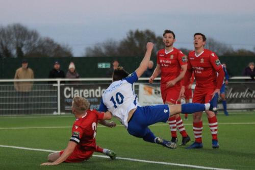 Enfields Josh Davison (10) and Hornchurchs Alex Bentley challenge for the ball which, judging by the eyes of the other two defenders, has gone straight up