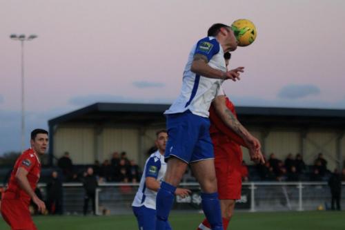 Enfields Matt Johnson (white) wins a header