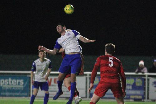 Enfields Matt Johnson challenges for a header