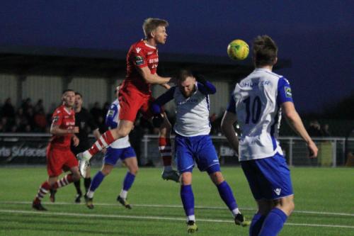 Hornchurchs Alex Bentley (red) wins a header against Billy Bricknell