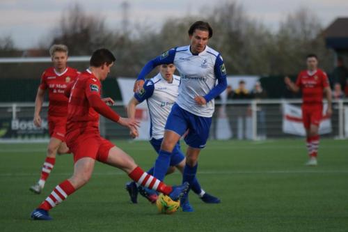Hornchurchs Glenn Wilson (red) challenges Sam Youngs