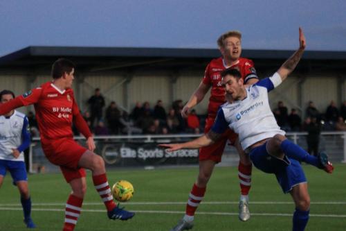 Hornchurchs Glenn Wilson clears after the ball beats Matt Johnson (R) and Alex Bentley