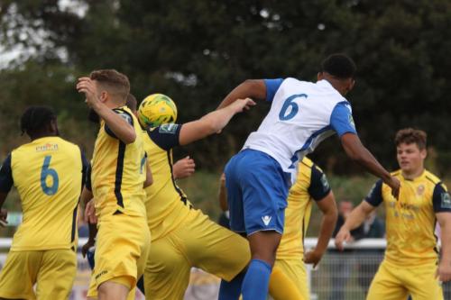 Enfields Rian McLean (white shirt) challenges at a corner