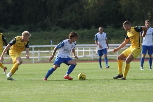 Hornchurchs Alex Bentley (L) and Conor Hogan and Enfields Sam Chaney