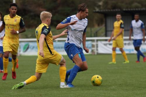 Hornchurchs Alex Bentley (L) challenges Sam Youngs