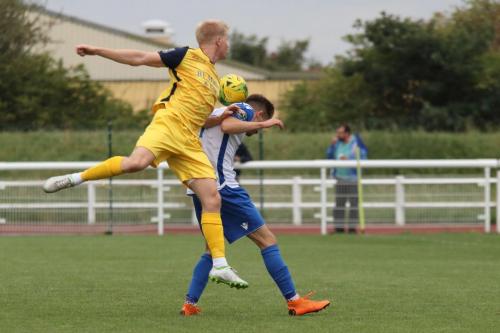 Hornchurchs Alex Bentley (yellow) challenges Bilal Sayoud