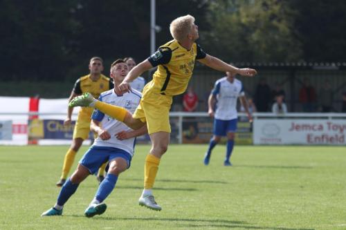 Hornchurchs Alex Bentley heads clear from Brandon Adams