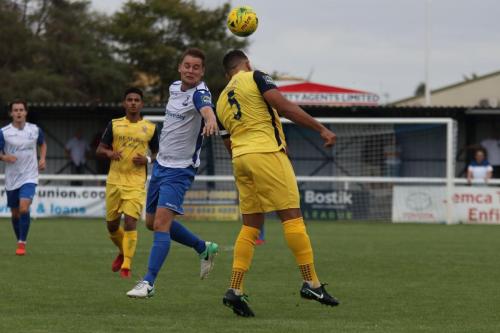 Hornchurchs Nathan Cooper (R) heads clear from Liam Hope