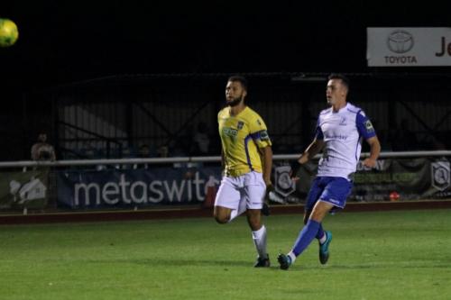 Enfields Brandon Adams (R) chips just over the bar